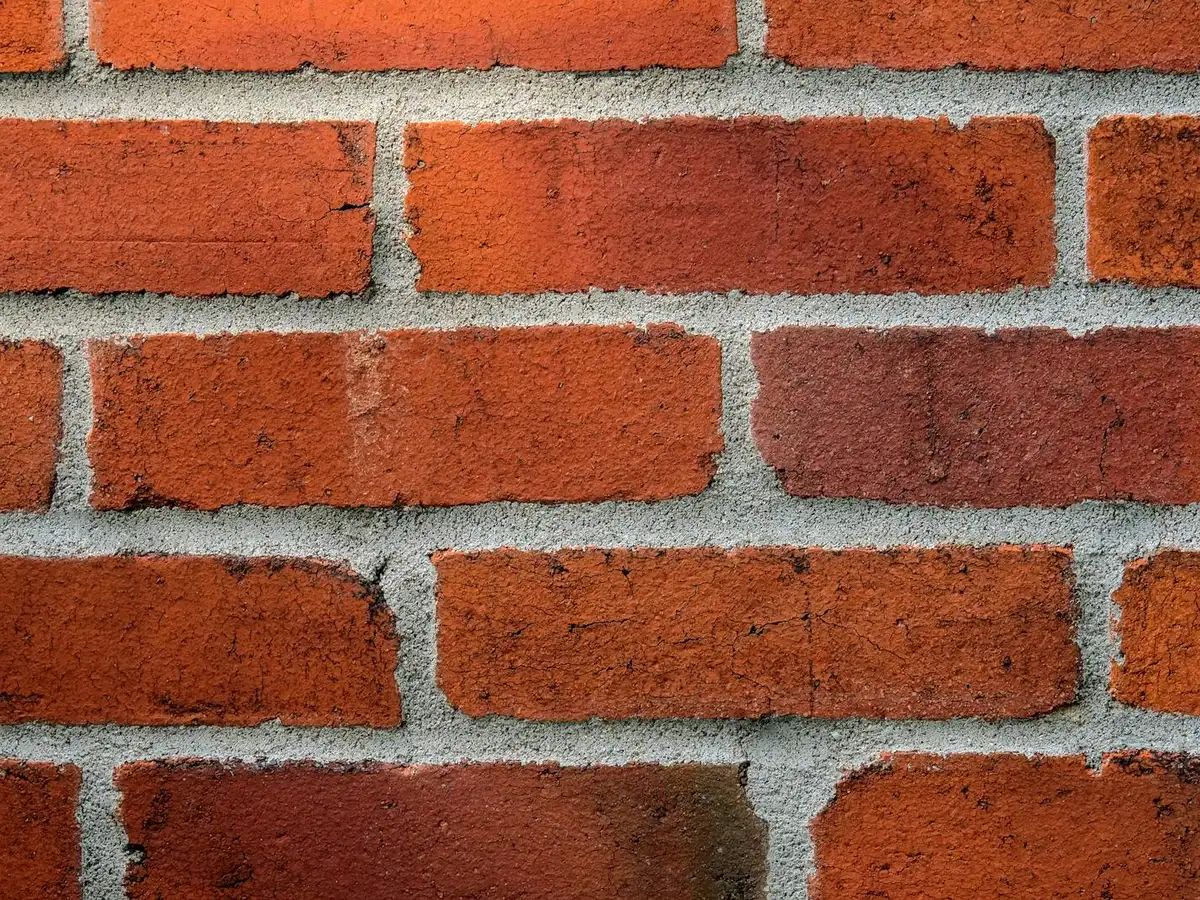 Brick wall with clean, even, tooled mortar joints.