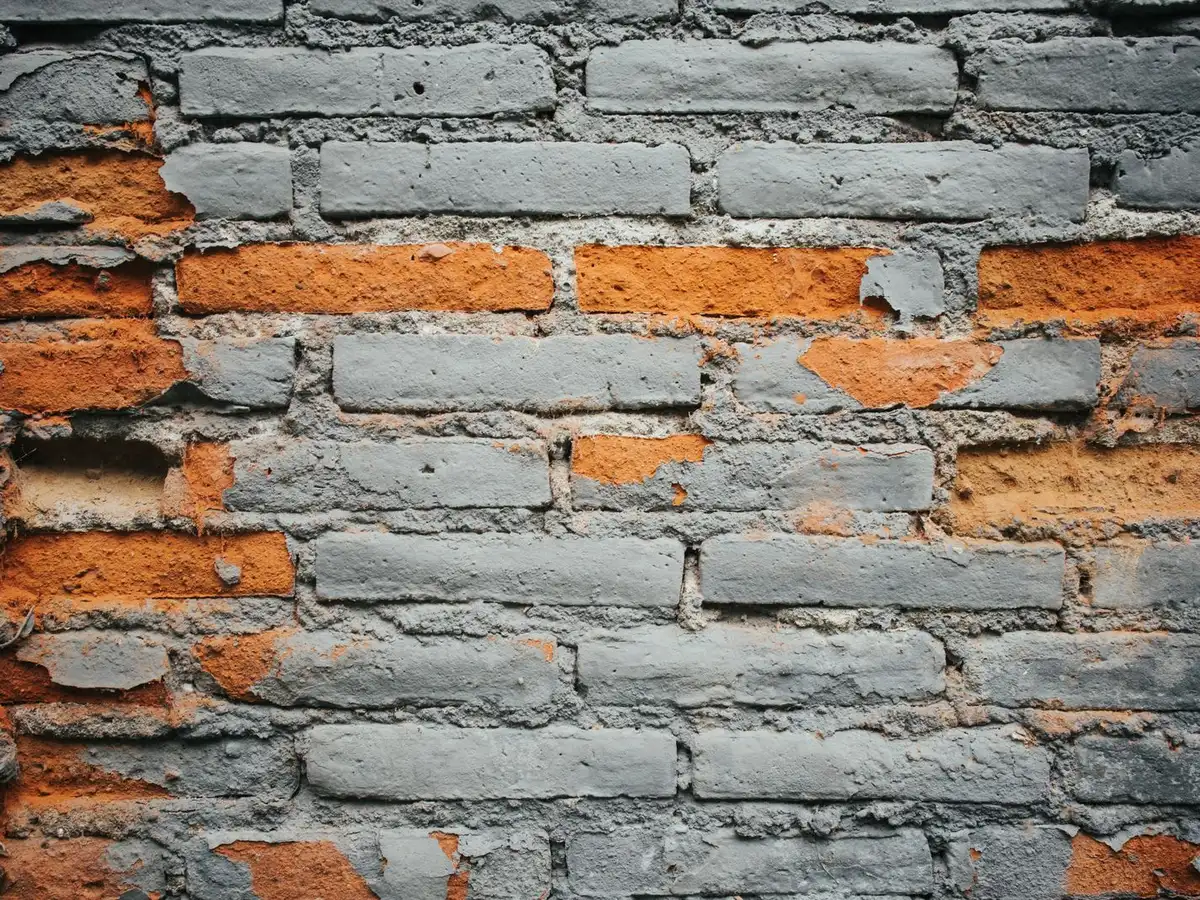 Weathered brick wall with eroded, recessed mortar joints.