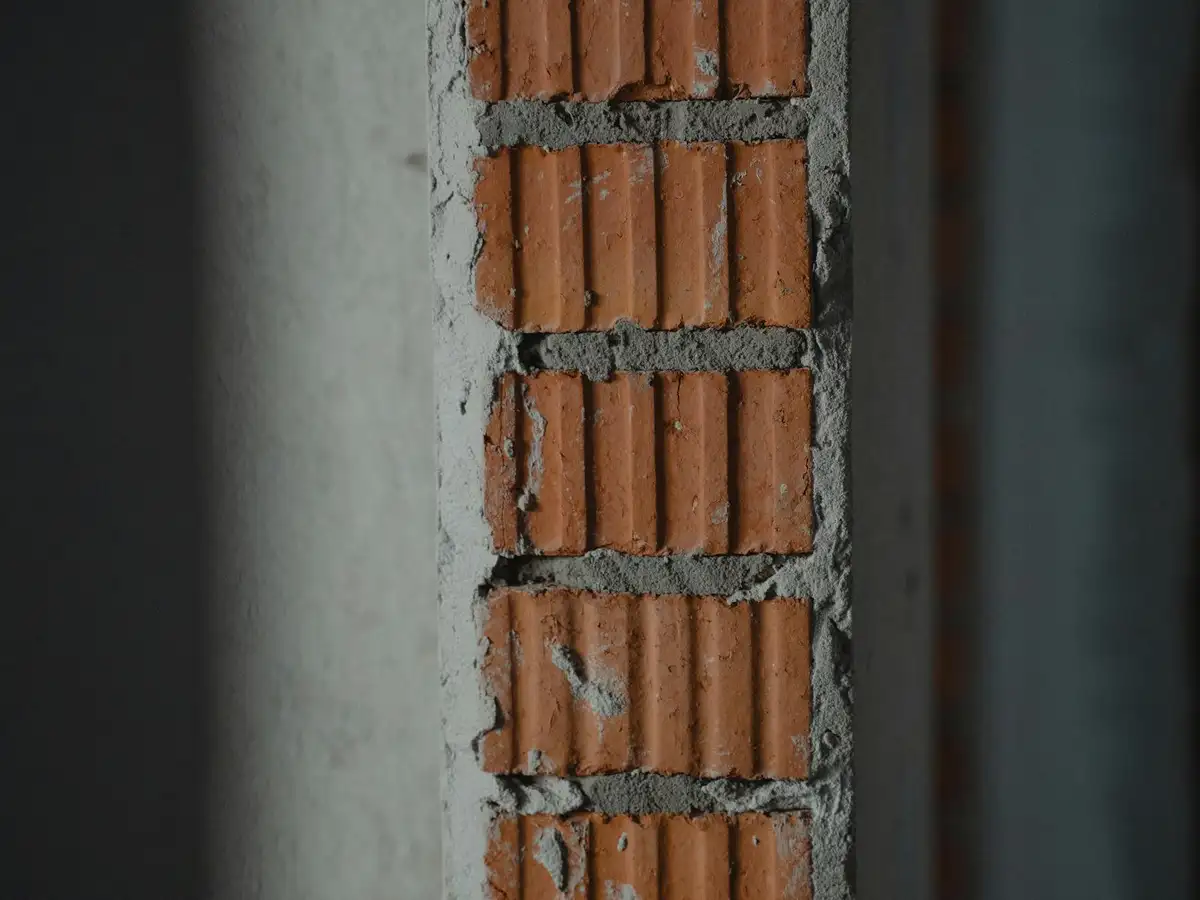 Brick wall with clean, even, freshly tooled mortar joints.