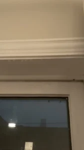 Interior water damage above a window traced to exterior masonry, Chicago