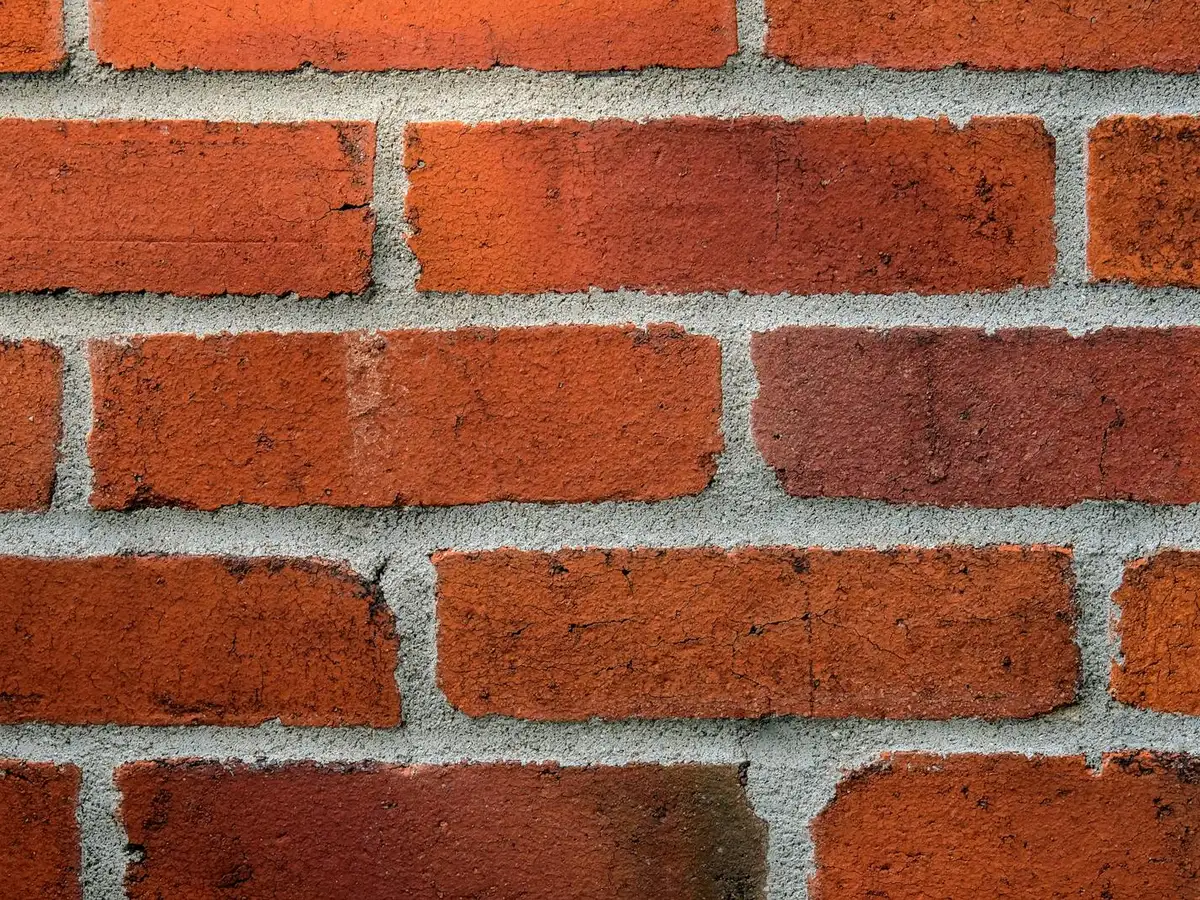 Brick wall with clean, even, tooled mortar joints.