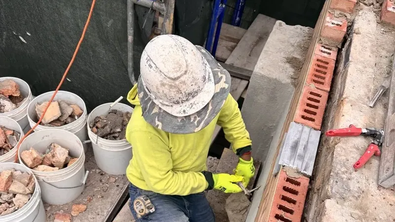 Mortar joints being repointed on a Chicago brick wall · Tuckpointing vs repointing — what’s the difference?